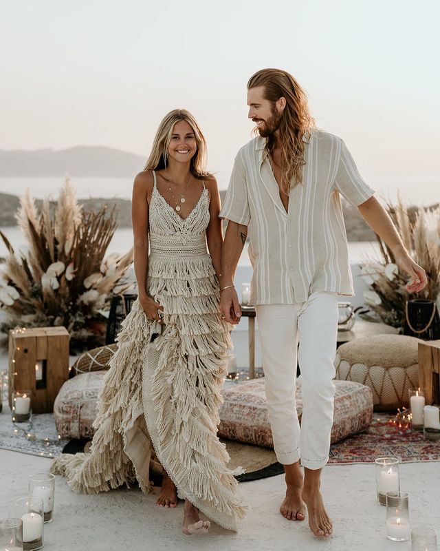 Marie Fe and Jake Snow at Ios Club, Greece, while she is wearing a handmade gown with crochet embroideries and an impressive fringe skirt by Atelier Zolotas