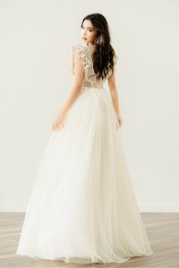 Bride in one of the most stunning boho ruffle wedding dresses by Atelier Zolotas, in vintage ivory color