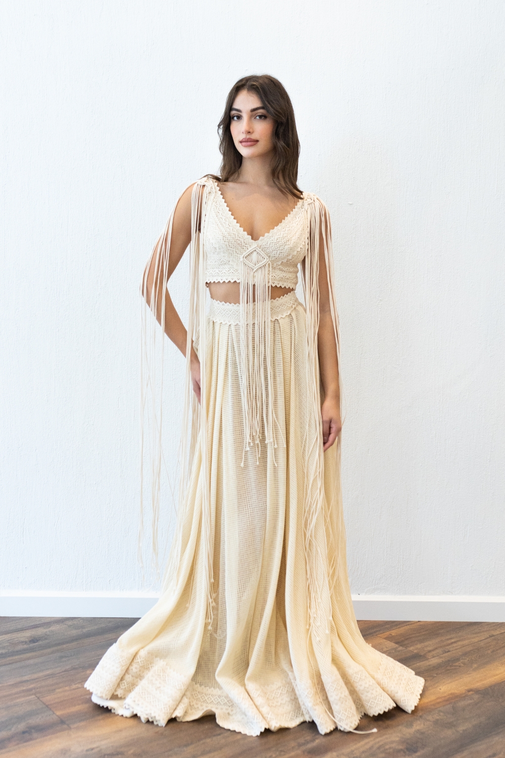 Model in the Isabel macrame crop top wedding dress by Atelier Zolotas featuring long cotton cords, vintage lace, and a breathable cotton net skirt.