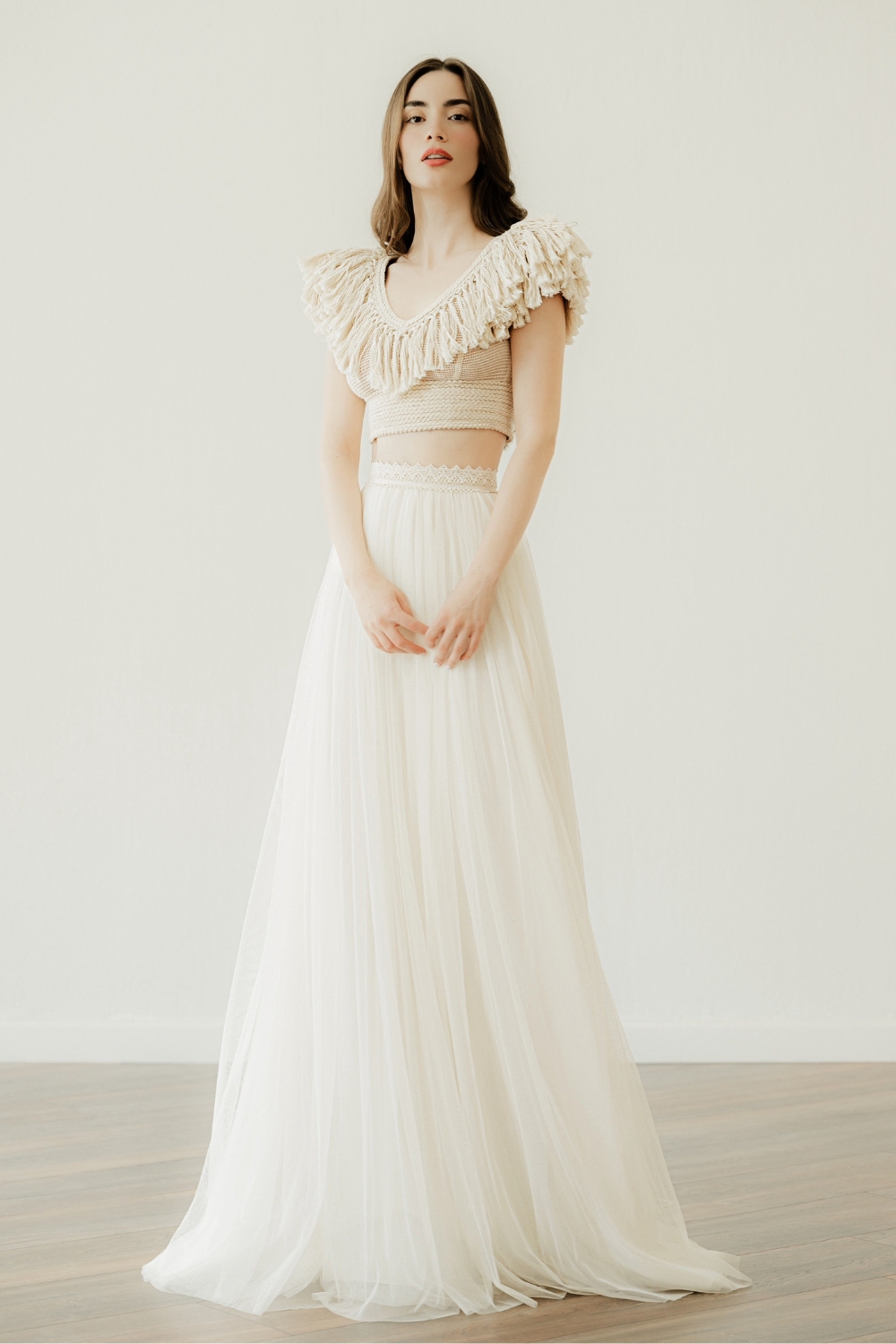 Model in 'Maraya', a handcrafted crop top fringe wedding dress by Atelier Zolotas
